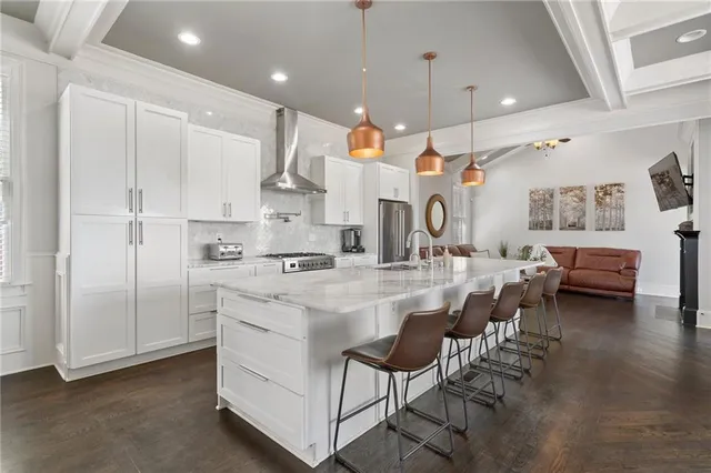 a large kitchen with kitchen island a stove a sink a dining table and chairs