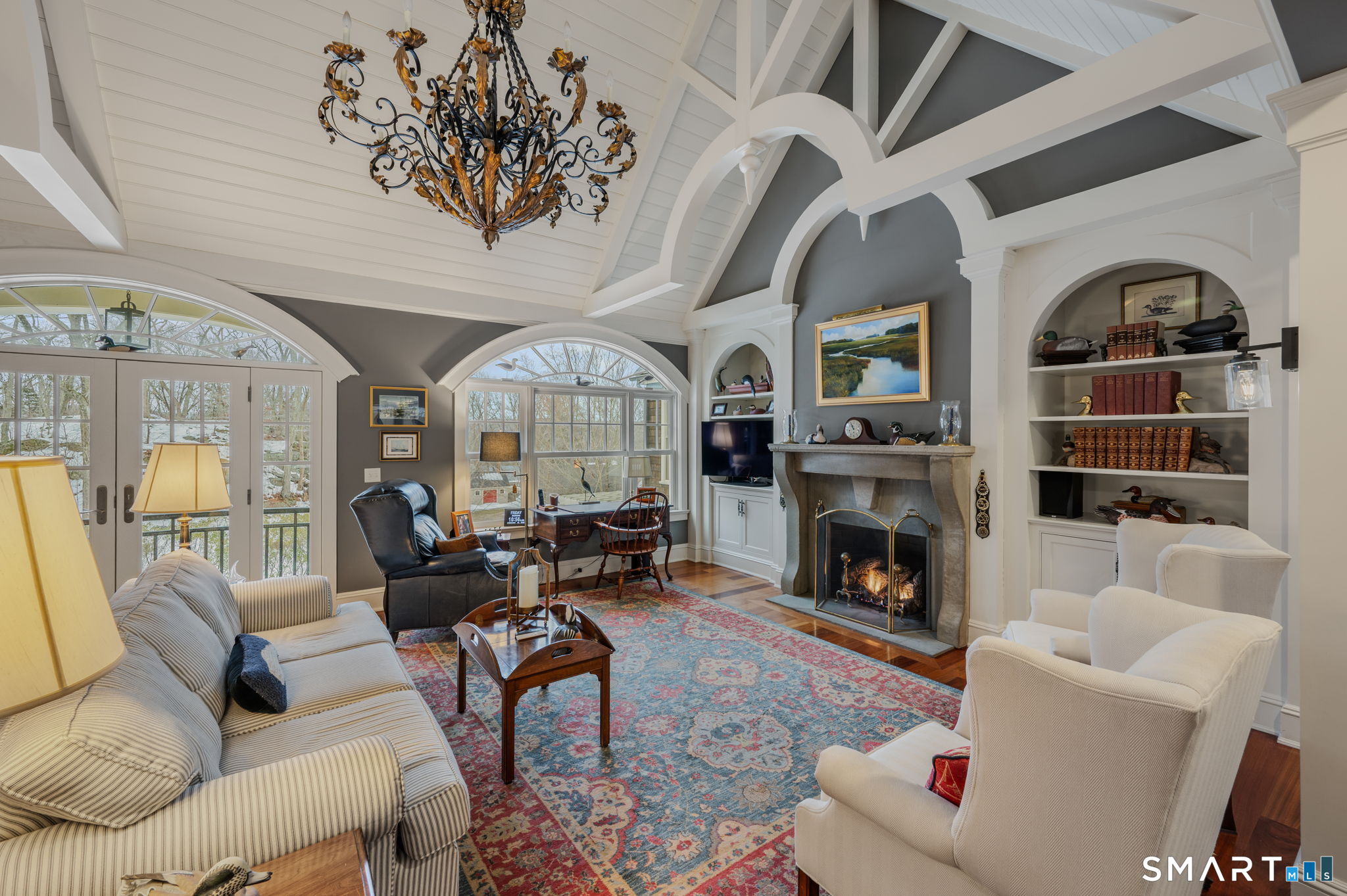 108 Westbrook Road Essex, CT 06409 - Photo 27 of 40 a living room with furniture a fireplace and a chandelier