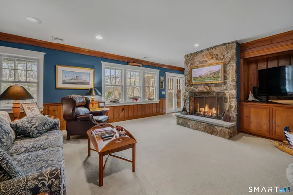 a living room with furniture a flat screen tv and a fireplace
