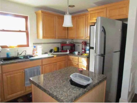 2529 Shaw Road West Brooklyn, IL 61378 - Photo 7 of 15 a kitchen with stainless steel appliances granite countertop a sink refrigerator and microwave