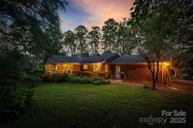 a backyard of a house with lots of green space and fountain