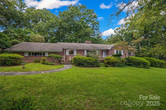 a view of a chair and table in backyard of the house
