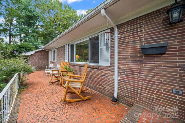 a backyard of a house with plants and large trees