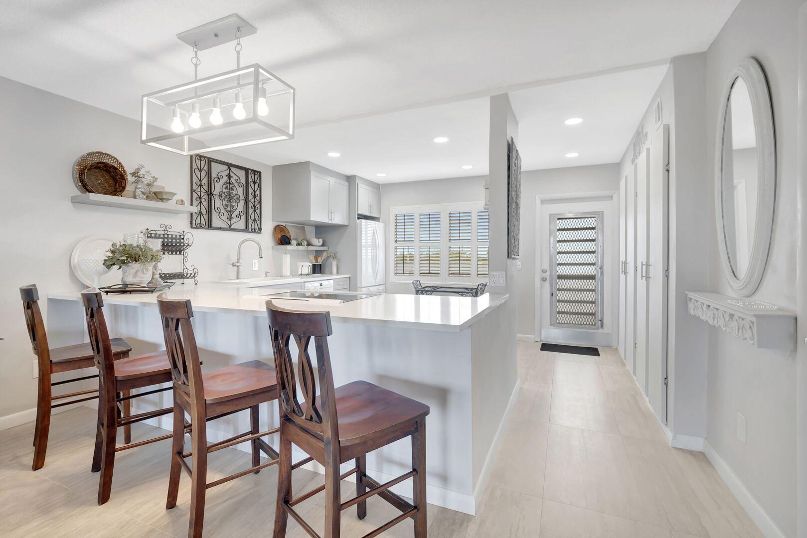 15 Southeast 13th Street, Unit D2 Boca Raton, FL 33432 - Photo 2 of 18 15 SE 13th KITCHEN WITH STOOLS