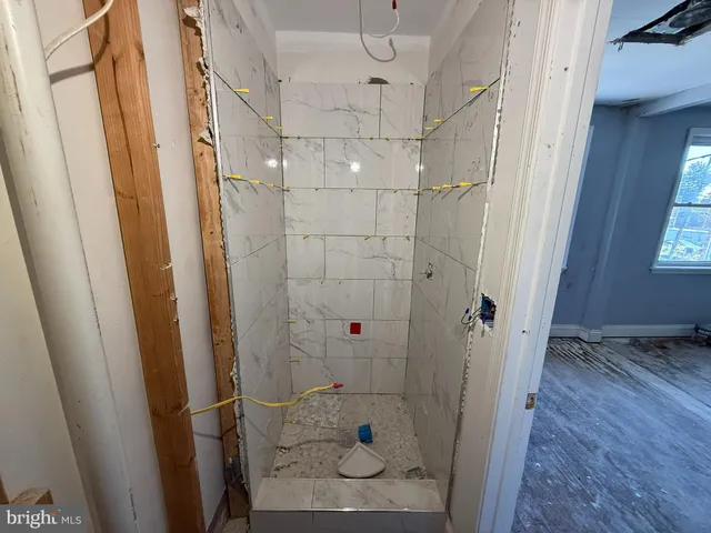 a bathroom with a sink a toilet and a shower