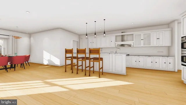 a kitchen with stainless steel appliances kitchen island granite countertop a table chairs and a refrigerator