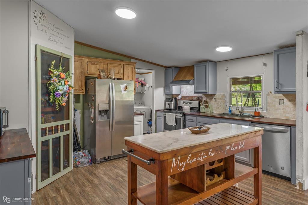 10660 Bowen Road Vivian, LA 71082 - Photo 11 of 27 a kitchen with stainless steel appliances granite countertop a stove a refrigerator and a sink