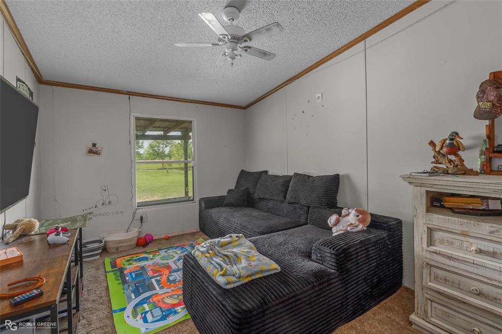 10660 Bowen Road Vivian, LA 71082 - Photo 13 of 27 a living room with furniture and a flat screen tv