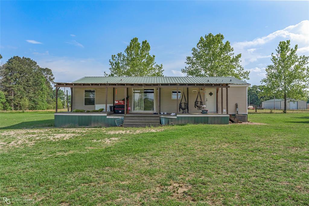 10660 Bowen Road Vivian, LA 71082 - Photo 19 of 27 a backyard of a house with table and chairs