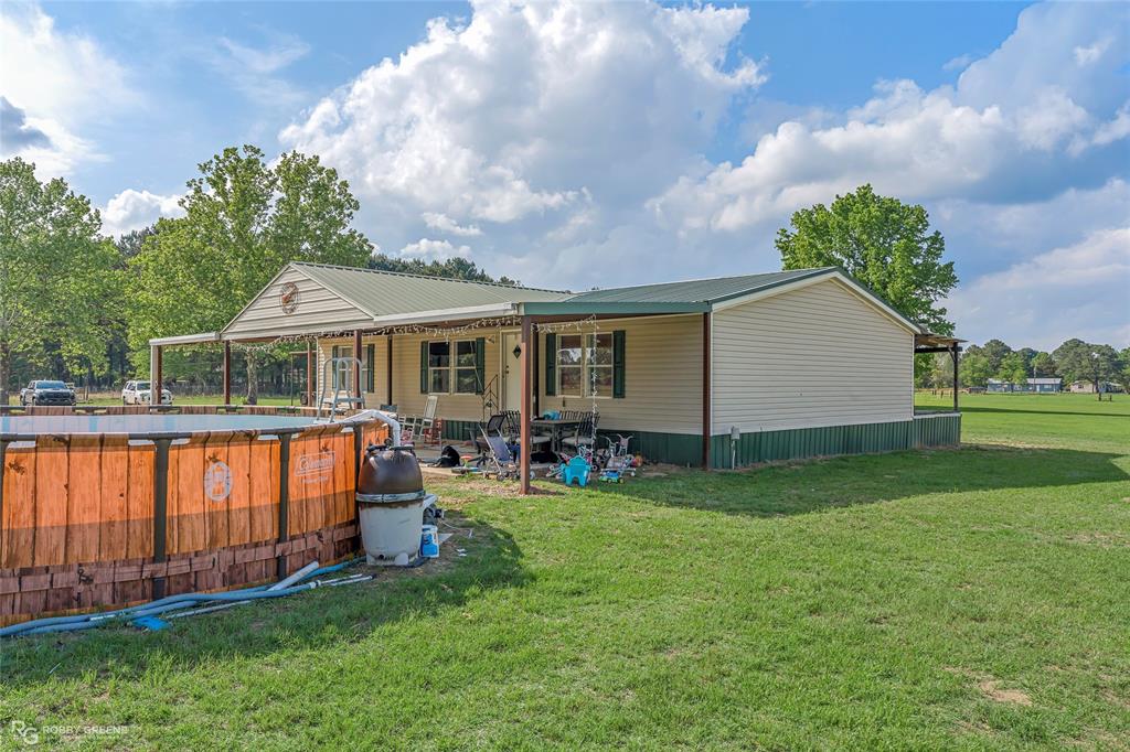 10660 Bowen Road Vivian, LA 71082 - Photo 20 of 27 a view of a house with a yard and sitting area