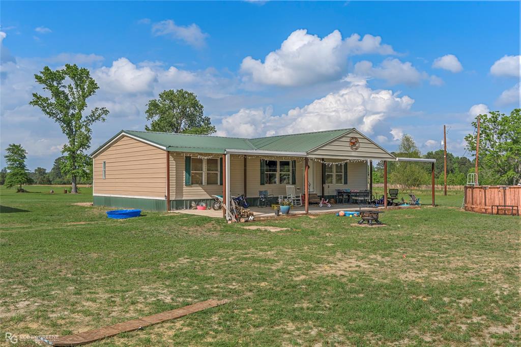 10660 Bowen Road Vivian, LA 71082 - Photo 2 of 27 a view of a house with backyard porch and sitting area