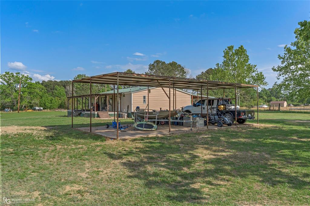 10660 Bowen Road Vivian, LA 71082 - Photo 22 of 27 a view of a house with backyard and sitting area