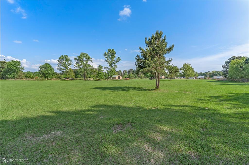 10660 Bowen Road Vivian, LA 71082 - Photo 24 of 27 a view of a grassy field with trees