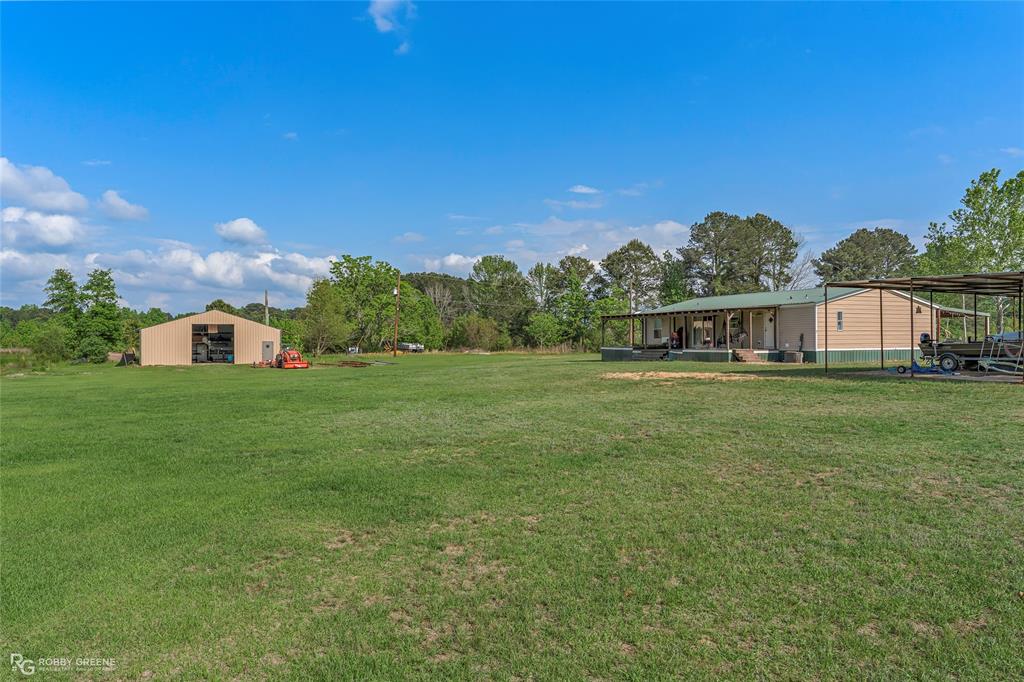 10660 Bowen Road Vivian, LA 71082 - Photo 27 of 27 a house view with swimming pool in front of it
