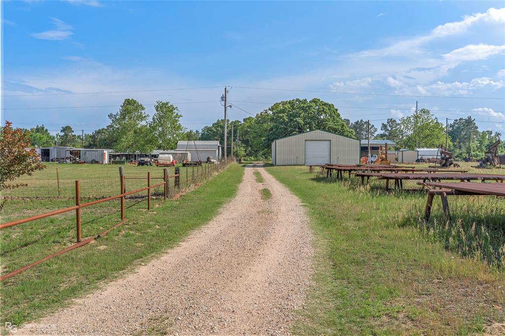 10660 Bowen Road Vivian, LA 71082 - Photo 3 of 27 a view of a lake with a yard and large trees