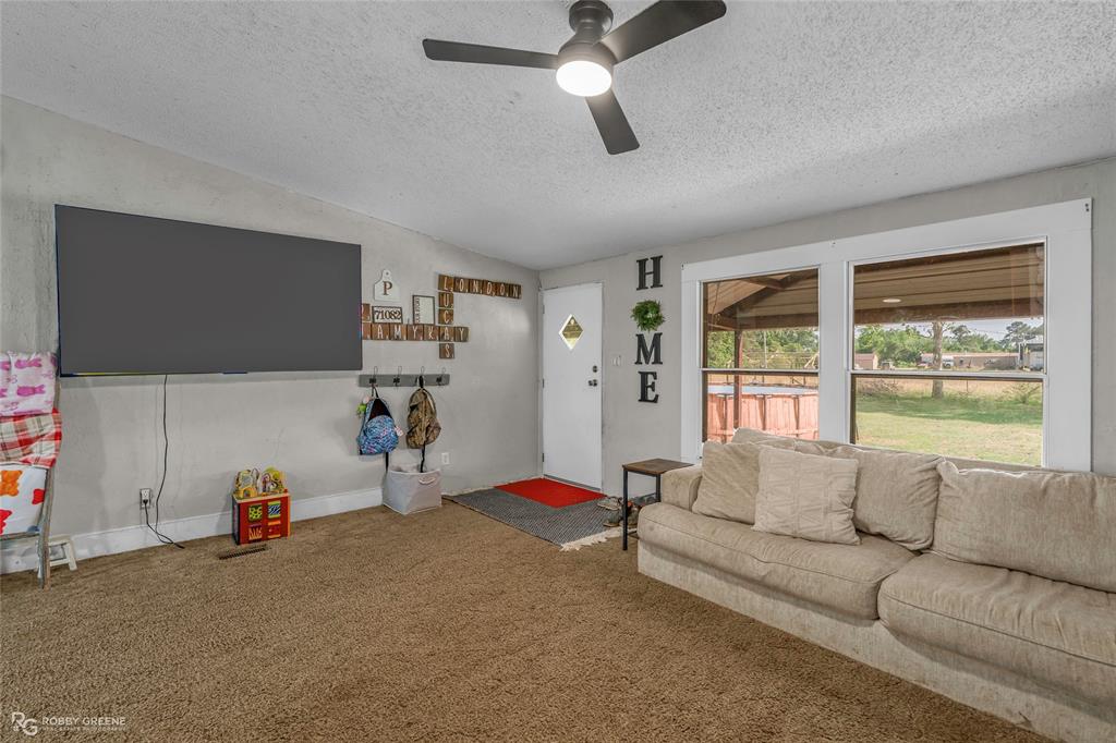 10660 Bowen Road Vivian, LA 71082 - Photo 6 of 27 a living room with furniture and a flat screen tv