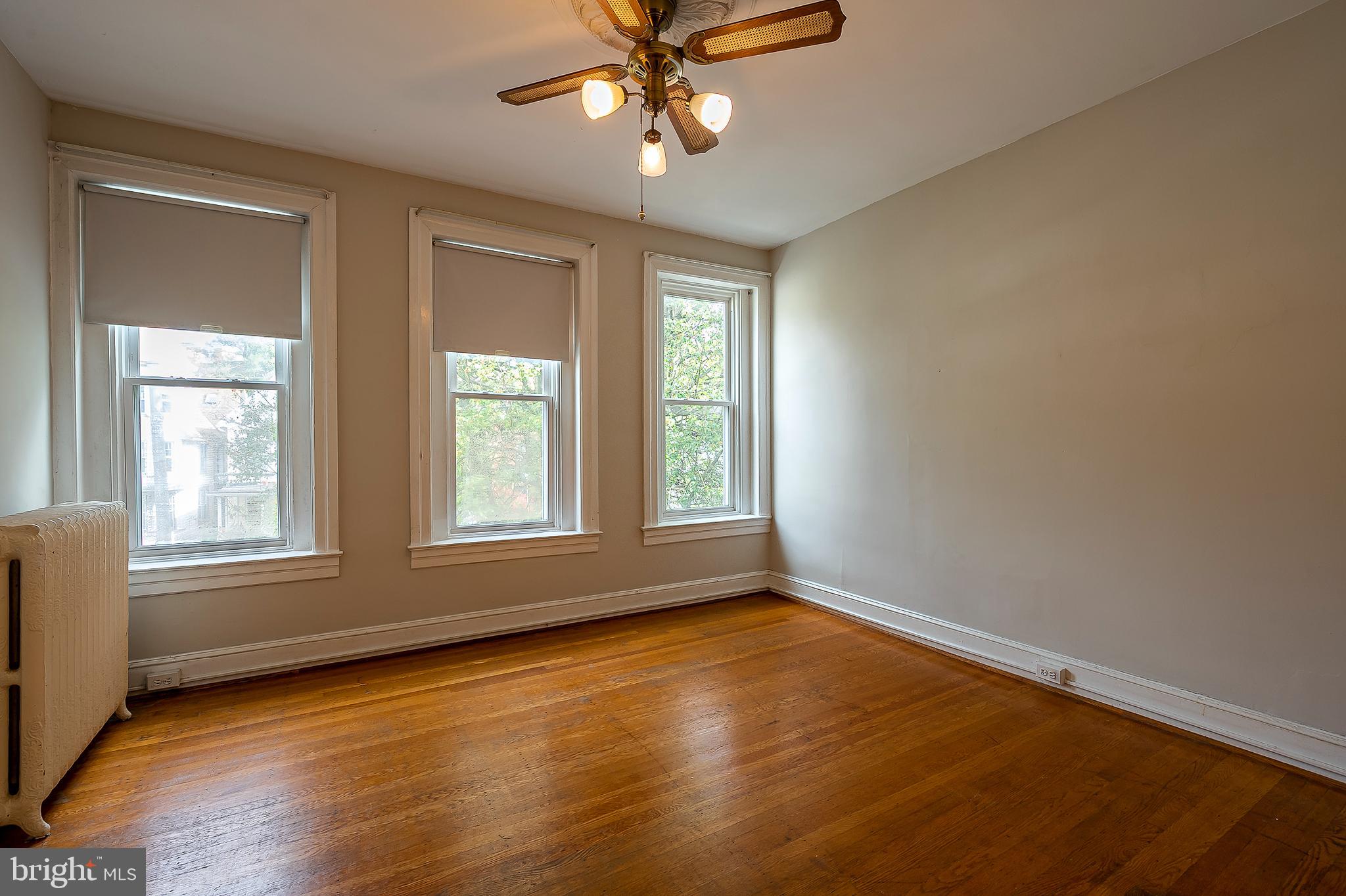 4018 Roland Avenue Baltimore, MD 21211 - Photo 20 of 27 a view of an empty room with wooden floor and a window