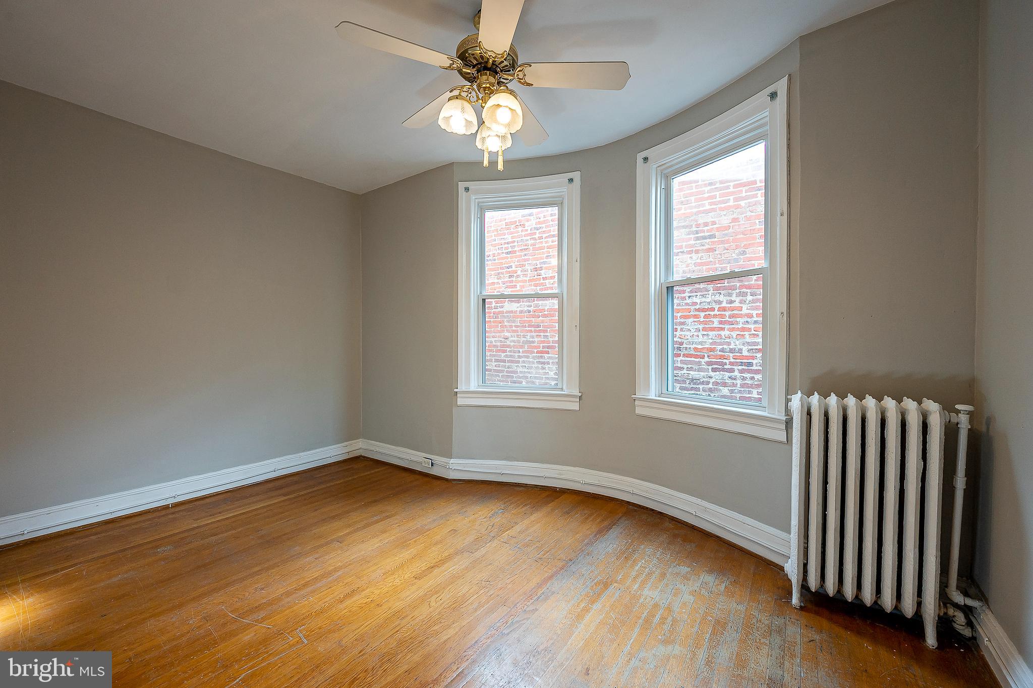 4018 Roland Avenue Baltimore, MD 21211 - Photo 22 of 27 a view of an empty room with wooden floor and a window