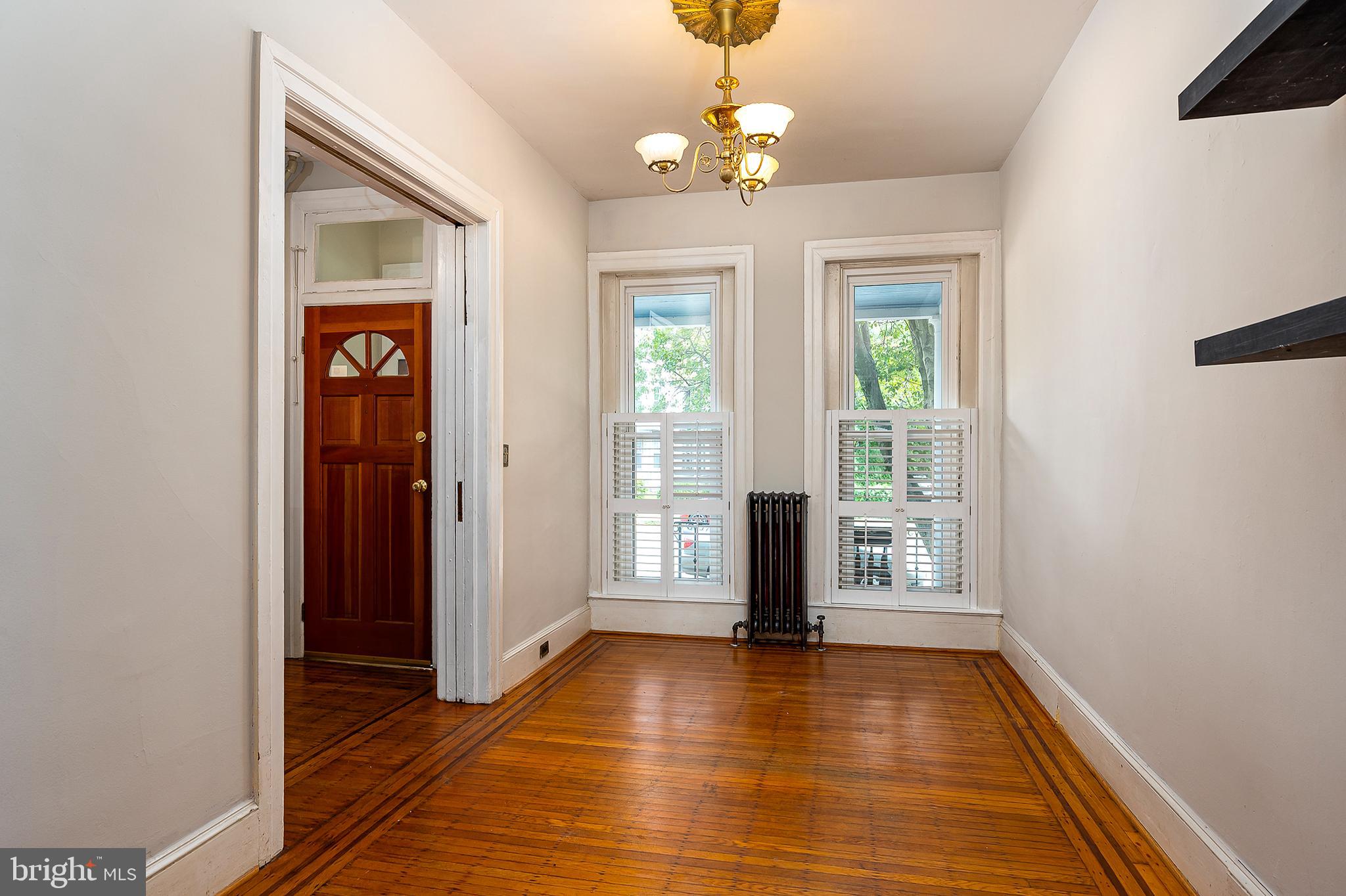 4018 Roland Avenue Baltimore, MD 21211 - Photo 5 of 27 a view of an empty room with wooden floor and a window