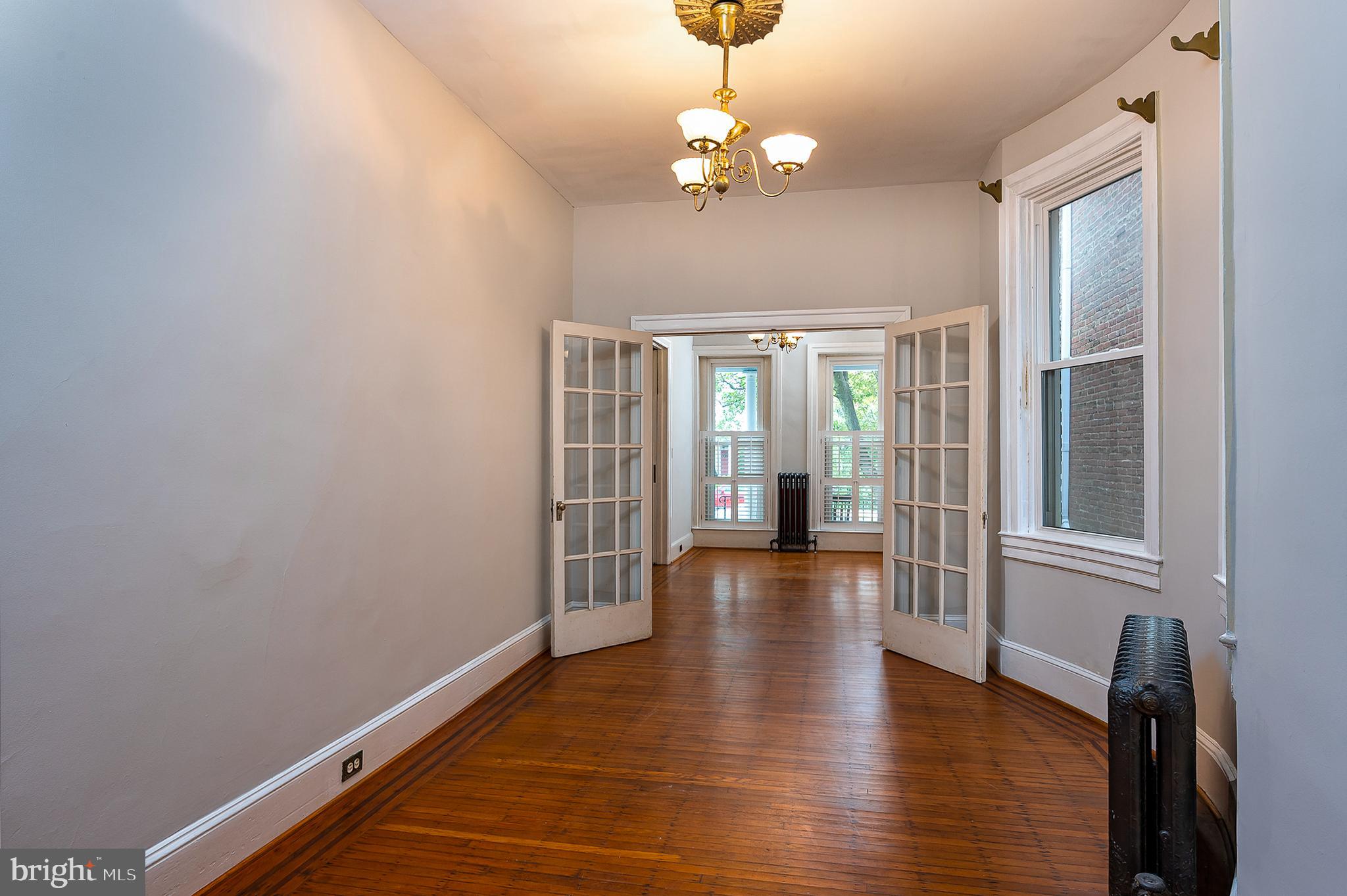 4018 Roland Avenue Baltimore, MD 21211 - Photo 8 of 27 a view of an empty room with wooden floor and a window