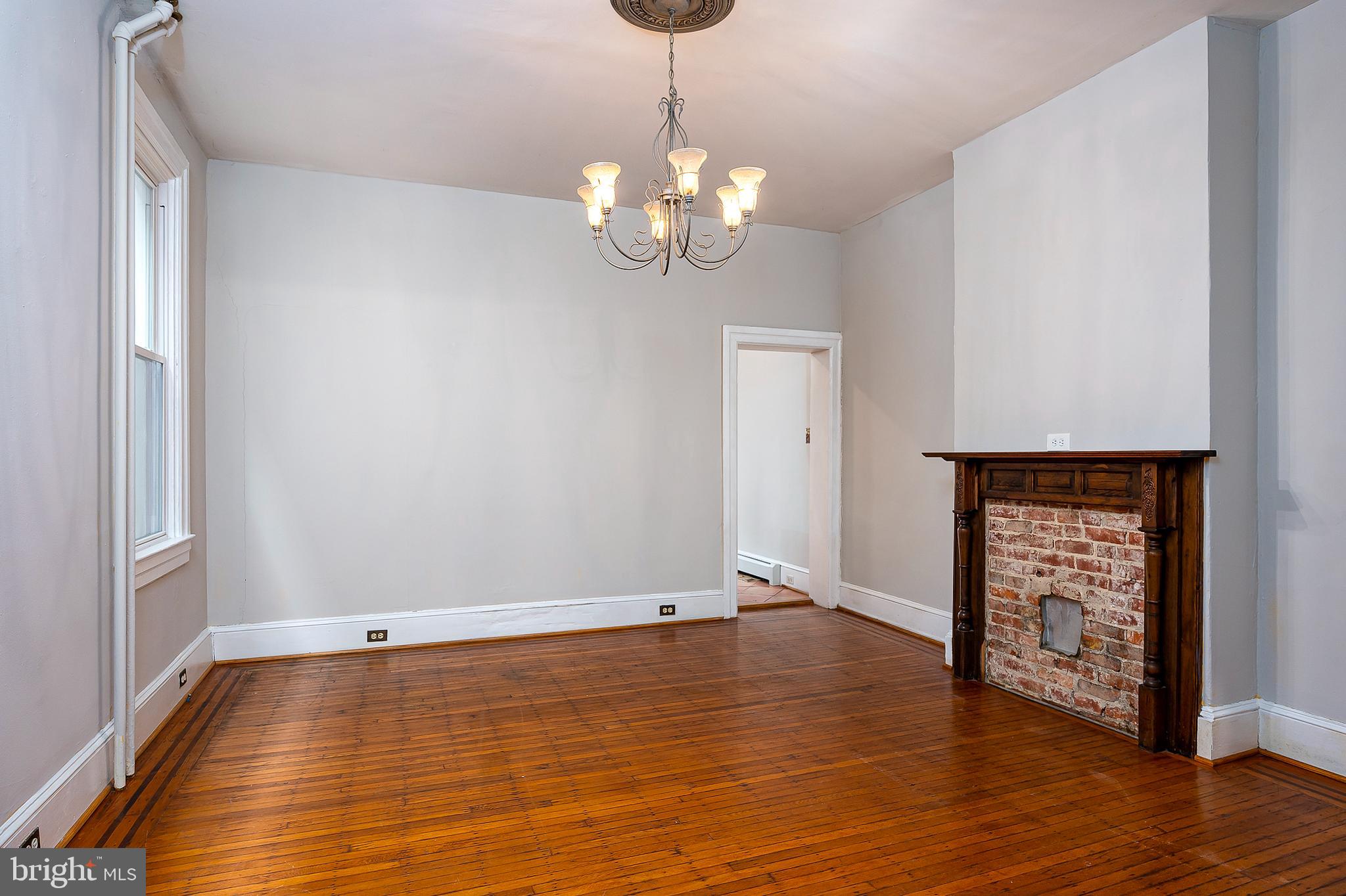 4018 Roland Avenue Baltimore, MD 21211 - Photo 9 of 27 a view of a room with wooden floor and chandelier