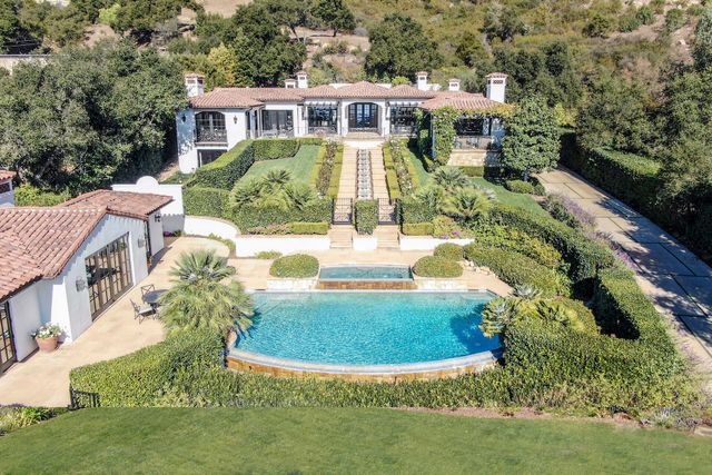 a kitchen with a stove a sink and a wooden floors