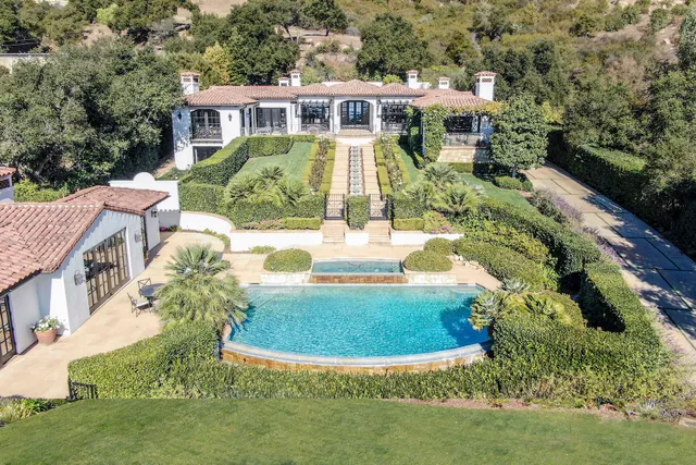 a kitchen with a stove a sink and a wooden floors