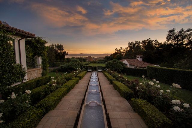 a living room with furniture a fireplace and a large window