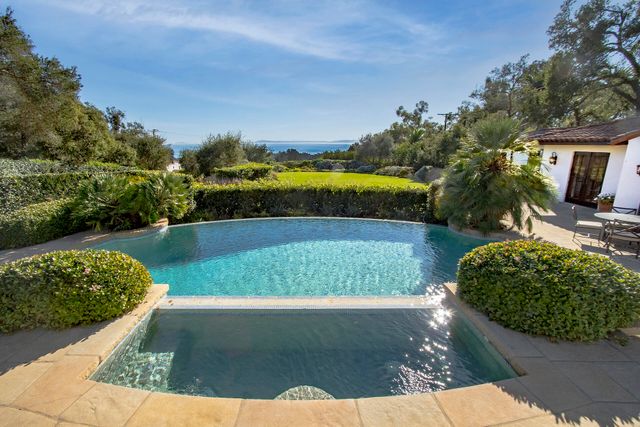 a bathroom with a sink a mirror and a shower