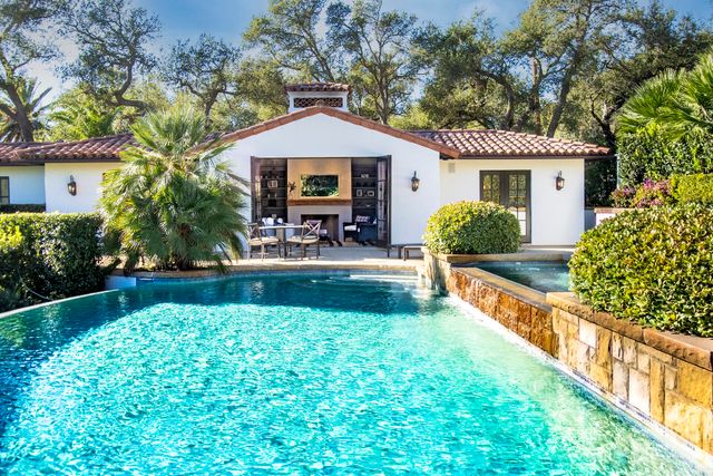 a bedroom with a large bed and a fireplace