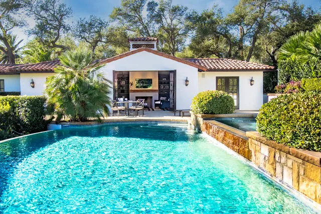 a bedroom with a large bed and a fireplace