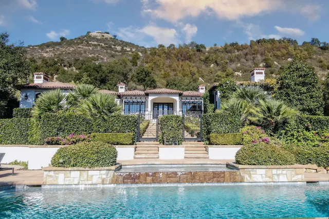 a bedroom with a bed and a fireplace
