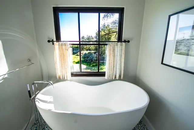 a spacious bedroom with a bed and a balcony