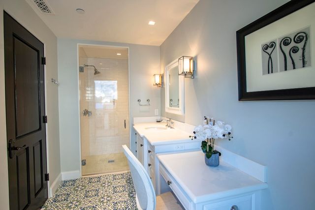 an aerial view of a house with a yard and large trees