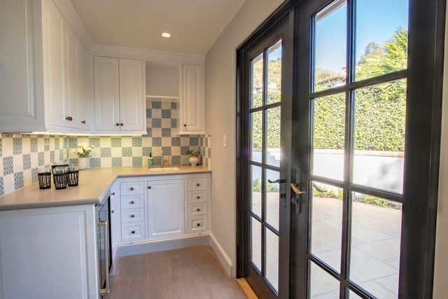 a view of a yard with plants and trees