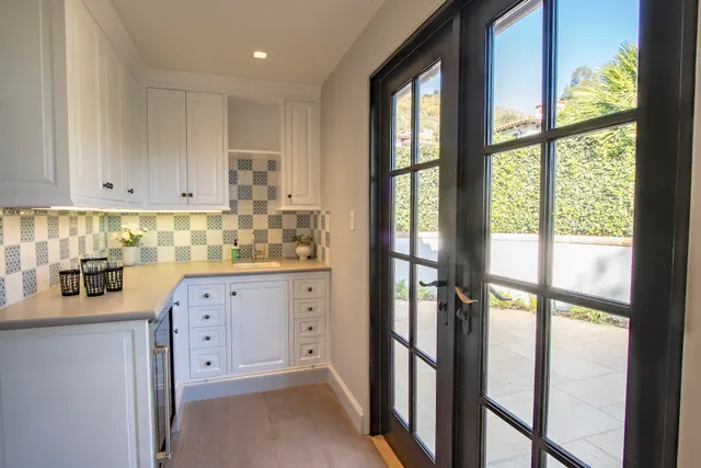 a view of a yard with plants and trees