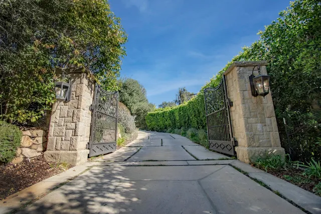 a dining room with furniture a chandelier and wooden floor