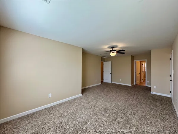 an empty room with a ceiling fan