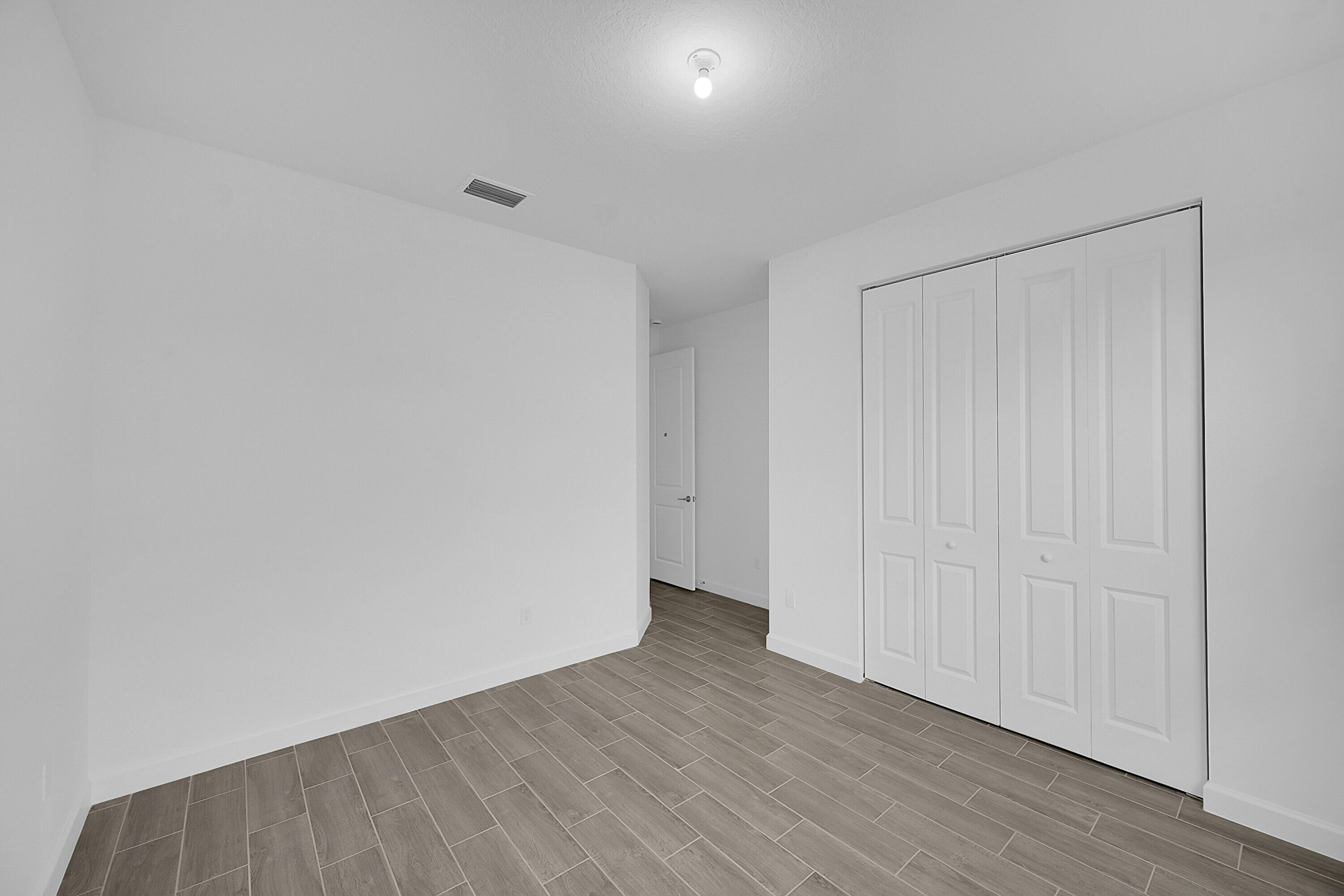 3550 Angler Drive Fort Pierce, FL 34946 - Photo 16 of 31 a view of an empty room with wooden floor