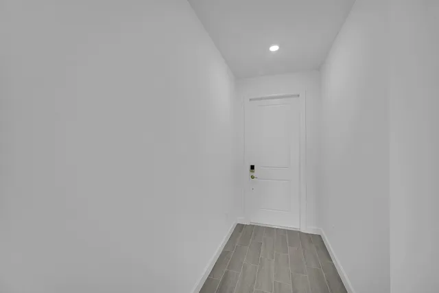 a view of a room with wooden floor