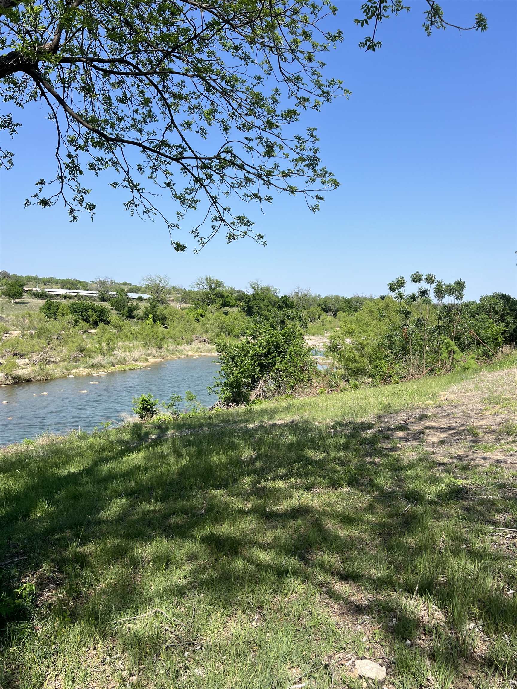 a view of a lake with a yard