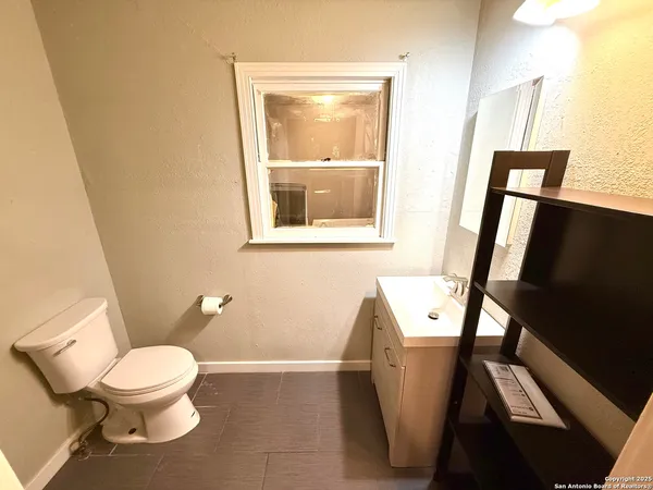 a bathroom with a toilet and a sink