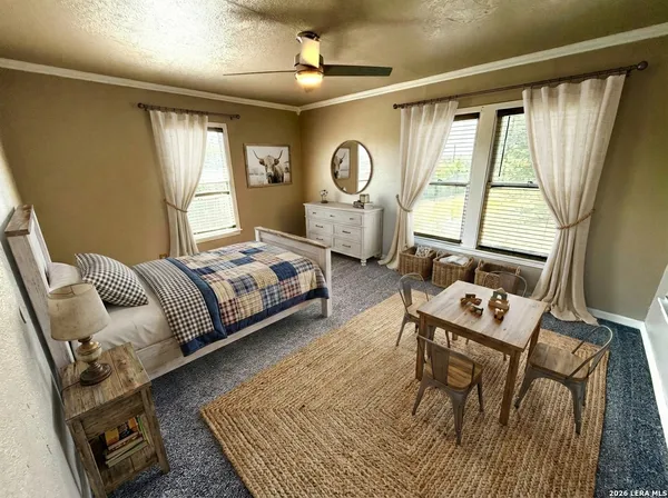 a bedroom with a bed a window and dresser