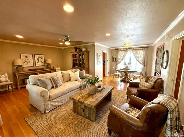 a living room with furniture and a chandelier