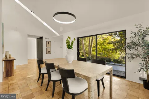 a spacious bedroom with a bed and glass door