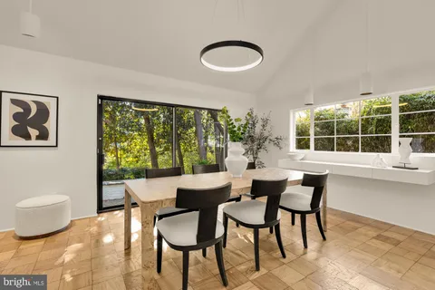 a spacious bedroom with a bed and a large window