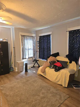 a bedroom with a bed and a couch