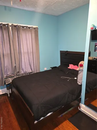 a bed sitting in a bedroom next to a window