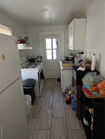 a kitchen with a sink and a stove top oven