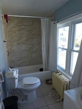 a bathroom with a toilet and a bathtub